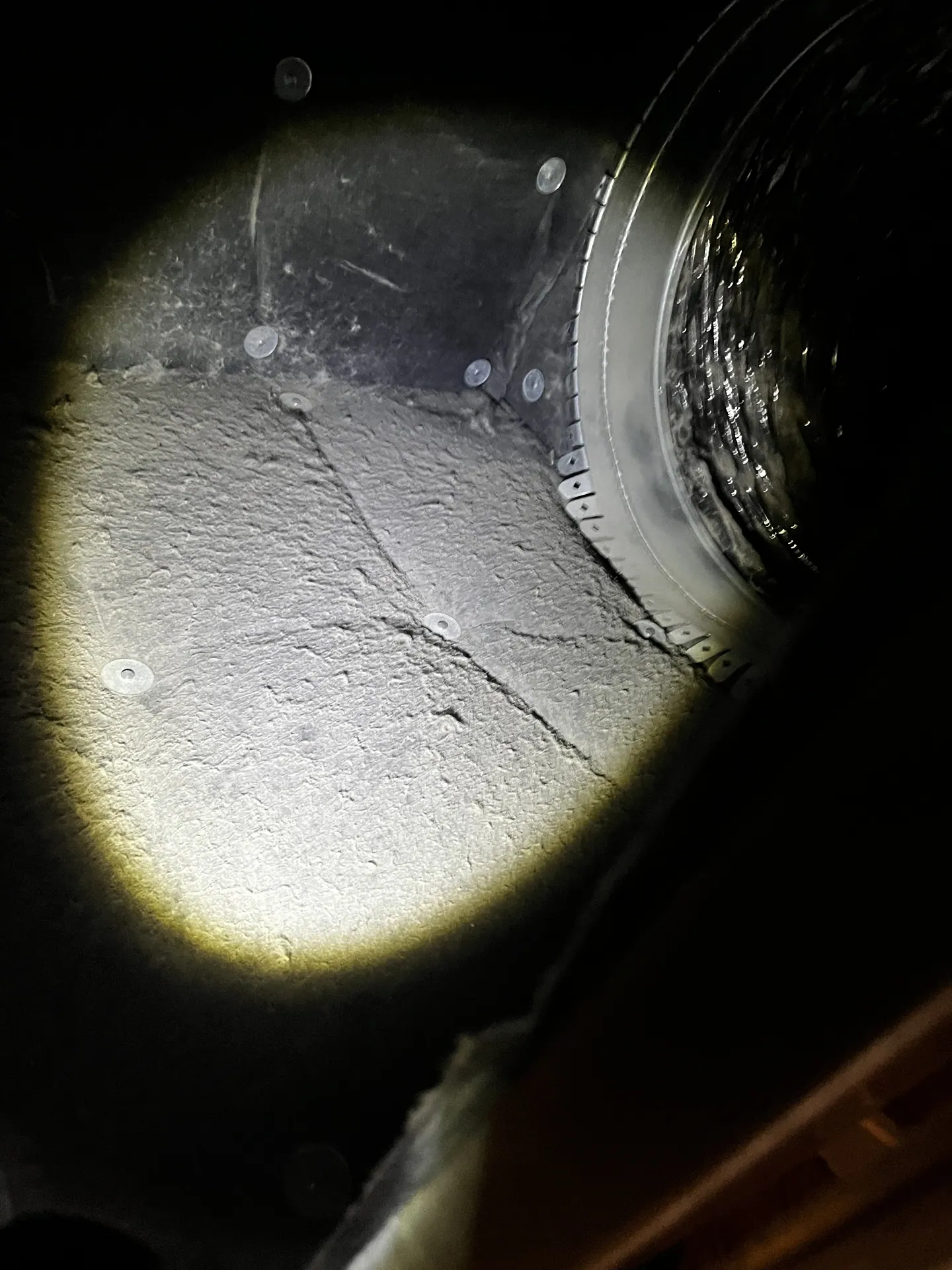 Accessible air-handler interior with settled dust during the limited attic assessment