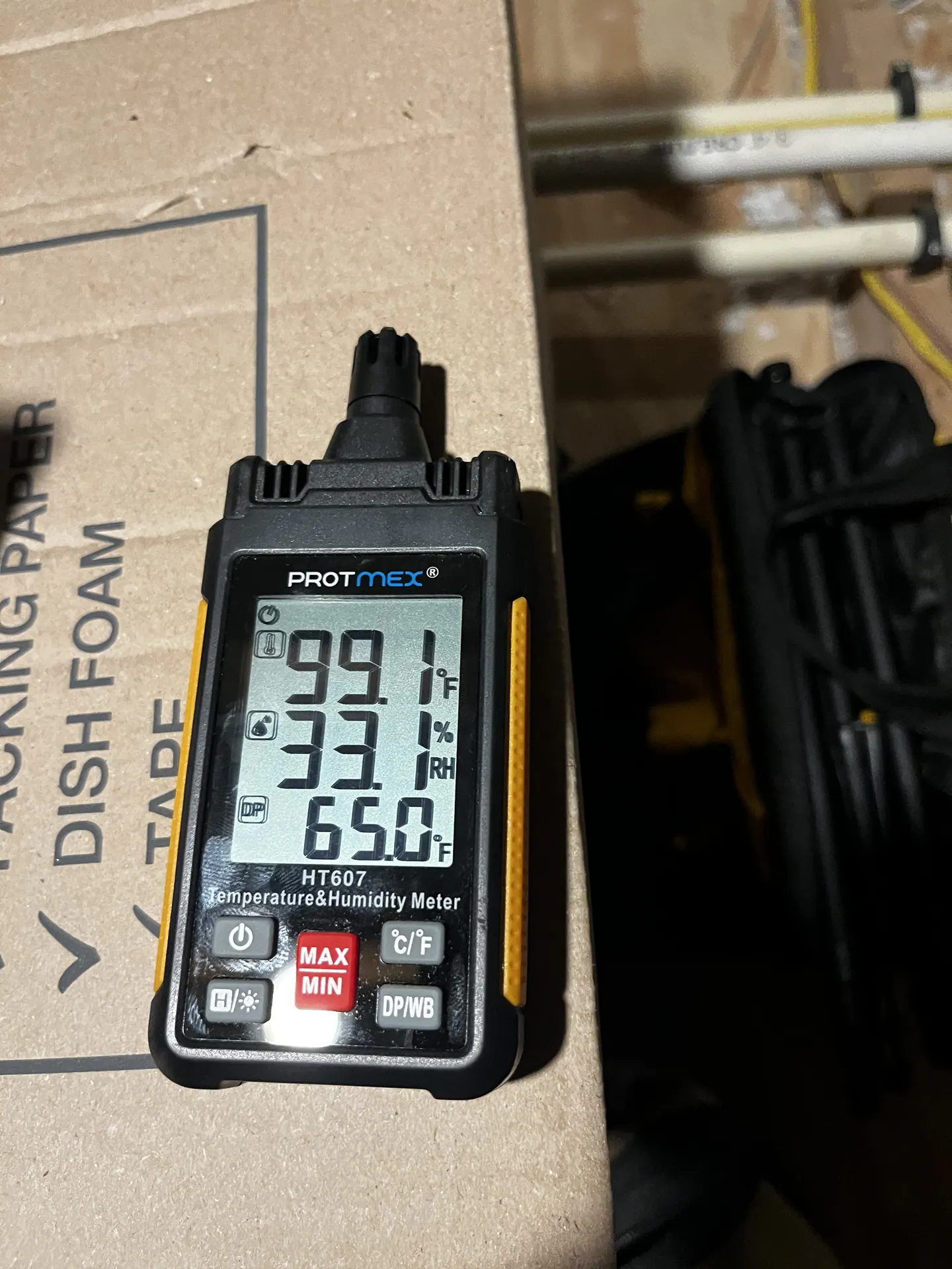 Attic instrument displaying 99.1 degrees Fahrenheit, 33.1 percent relative humidity and 65.0 degrees Fahrenheit dew point