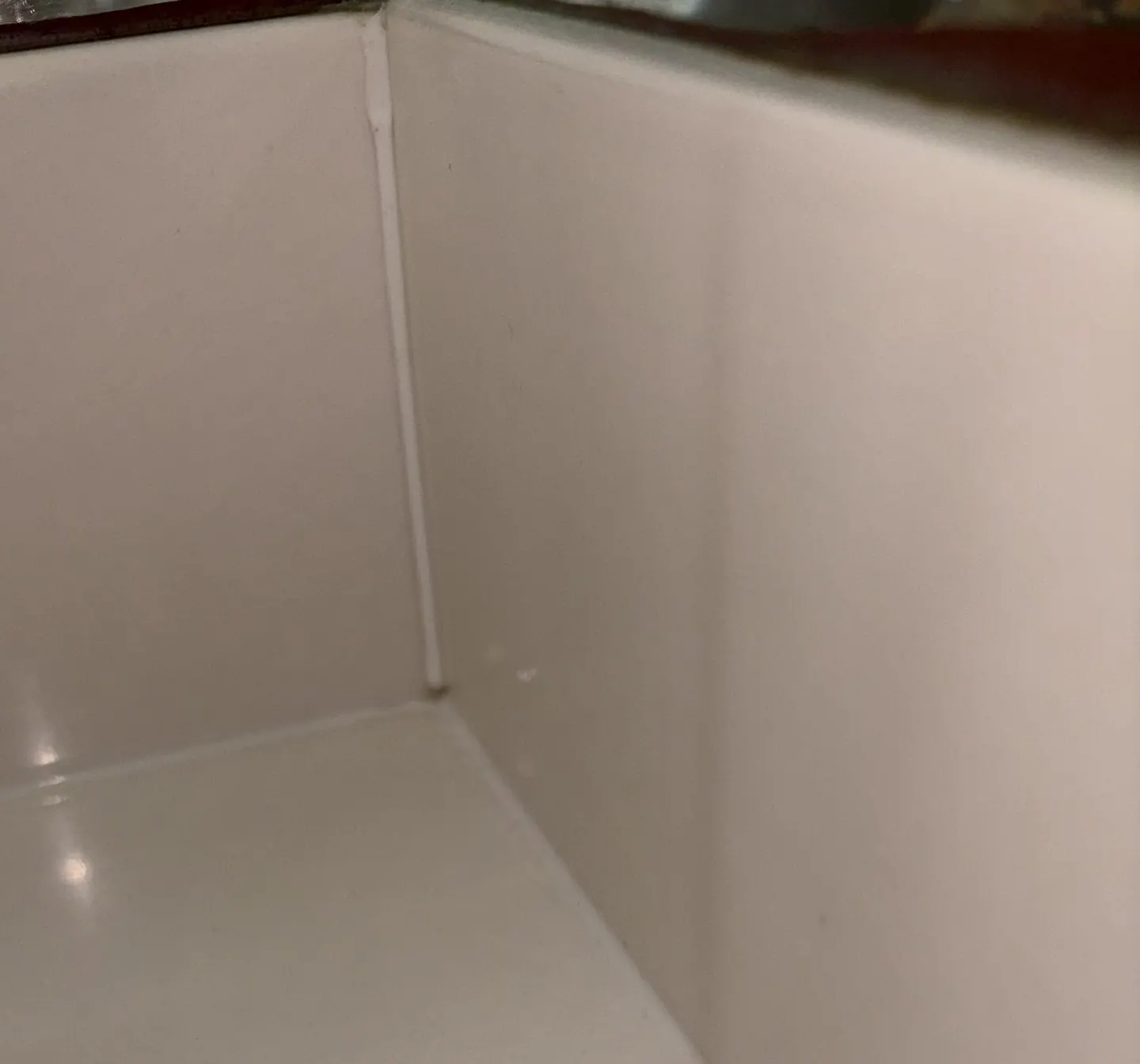 Rear corner joint inside bathroom vanity investigated as a possible moisture path