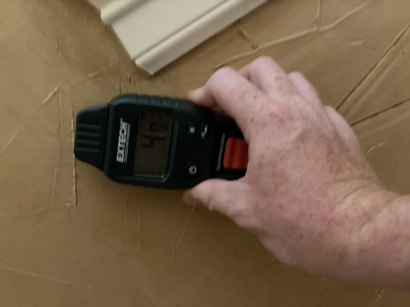 Moisture meter showing a 4.0 comparative response at a Bathroom #1 wall reference