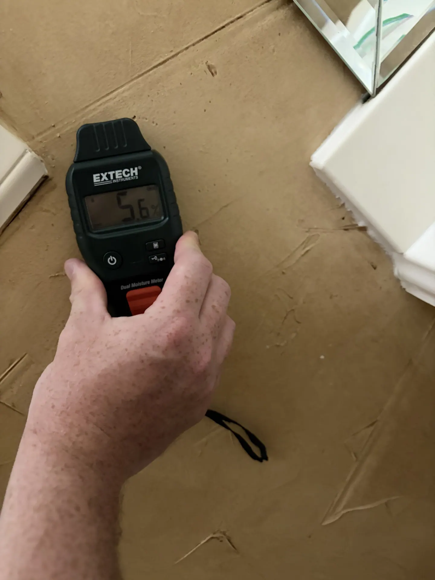 Moisture meter showing a 5.6 comparative response at another Bathroom #1 wall reference