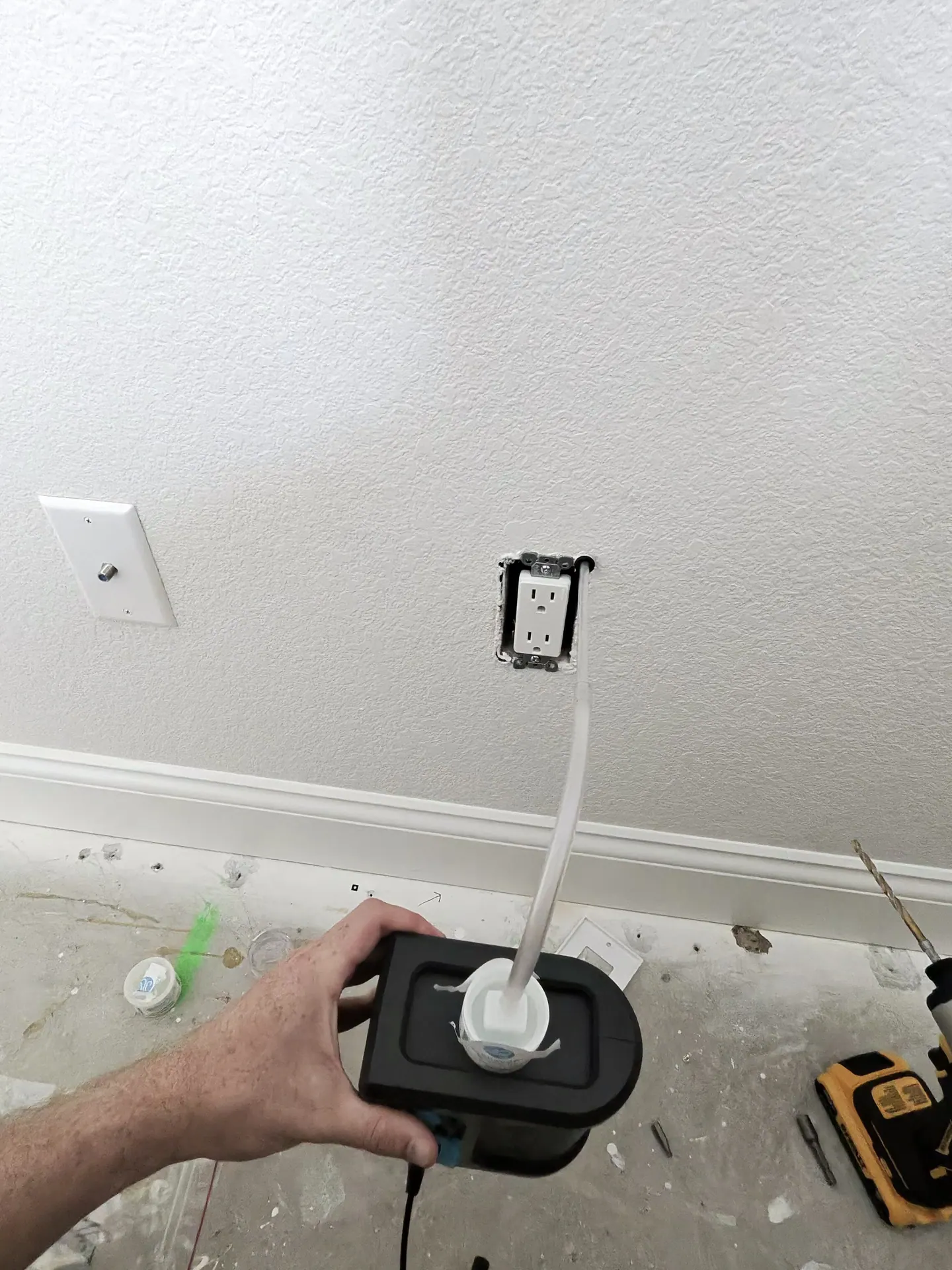 Wall-cavity air sampling through an existing outlet opening near the exposed master-closet slab