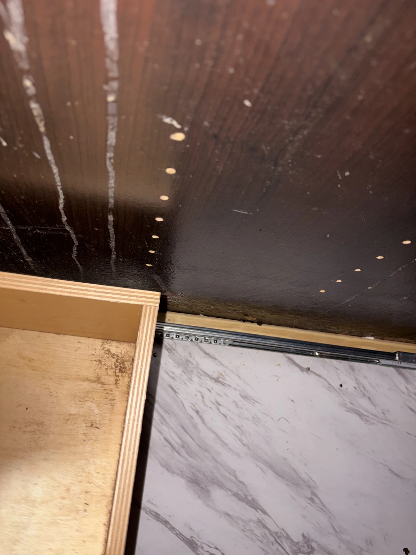 Streaking and finish deterioration on adjacent kitchen-island drawer-bay panel