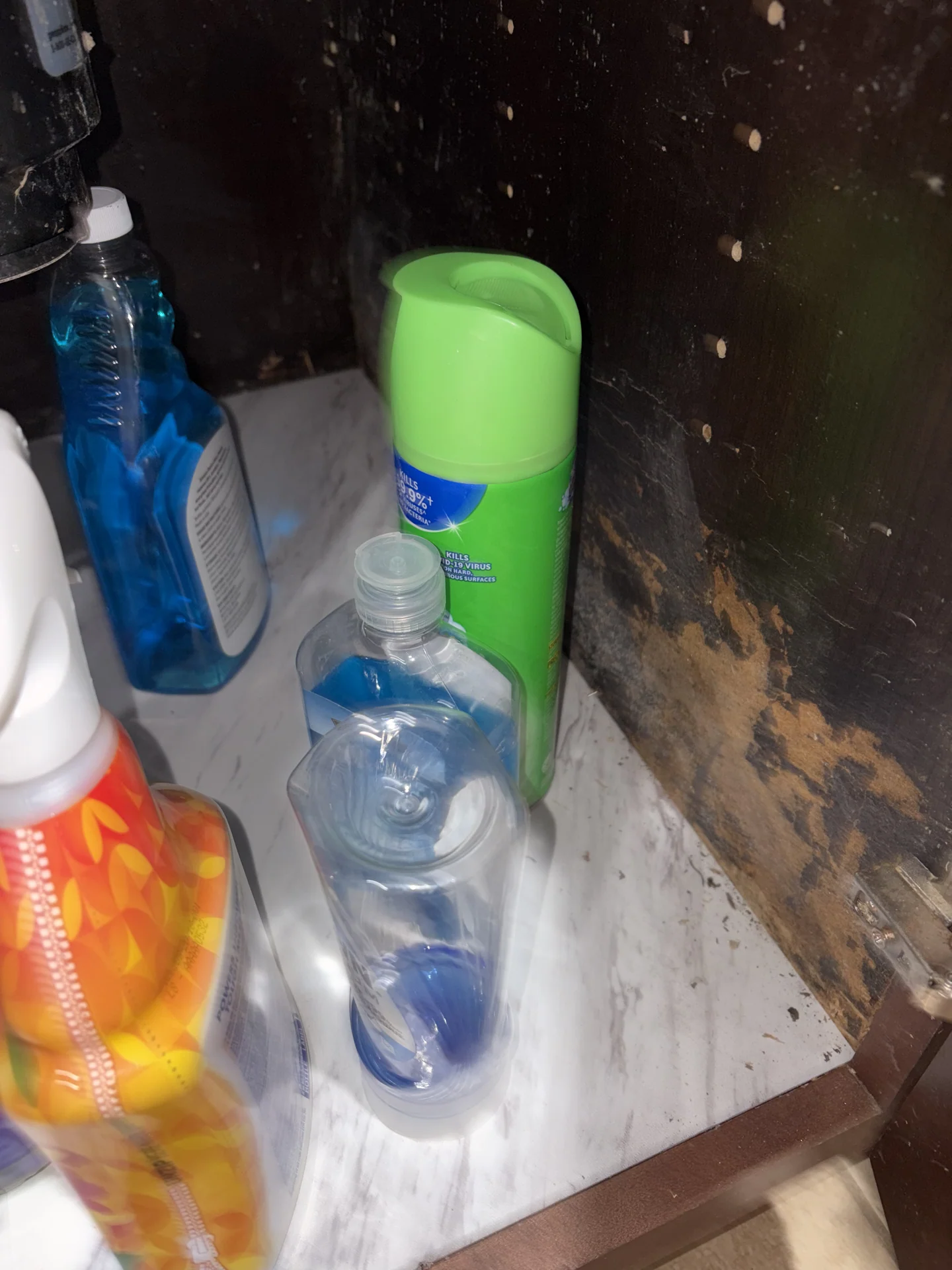 Dark fungal discoloration inside kitchen island sink cabinet after dishwasher leak