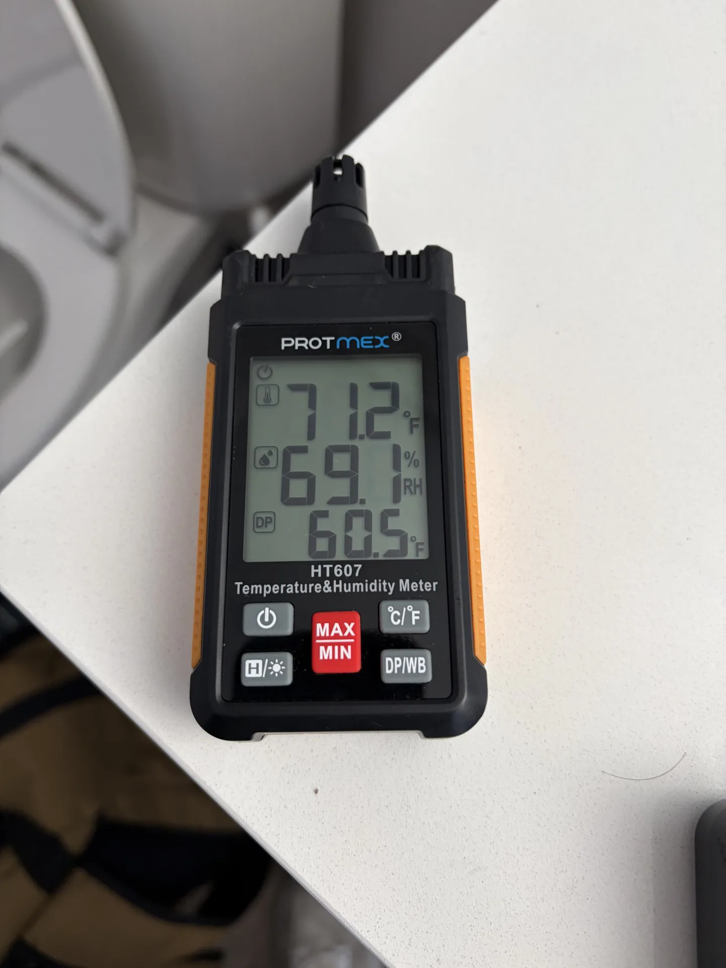Second-floor bathroom hygrometer displaying 71.2 degrees Fahrenheit, 69.1 percent relative humidity and a 60.5 degree Fahrenheit dew point