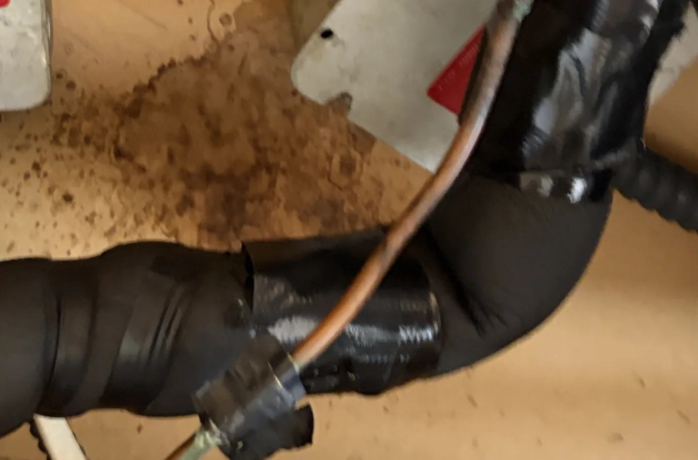 Previously water-stained ceiling materials beside the HVAC handler serving the top-floor bathroom