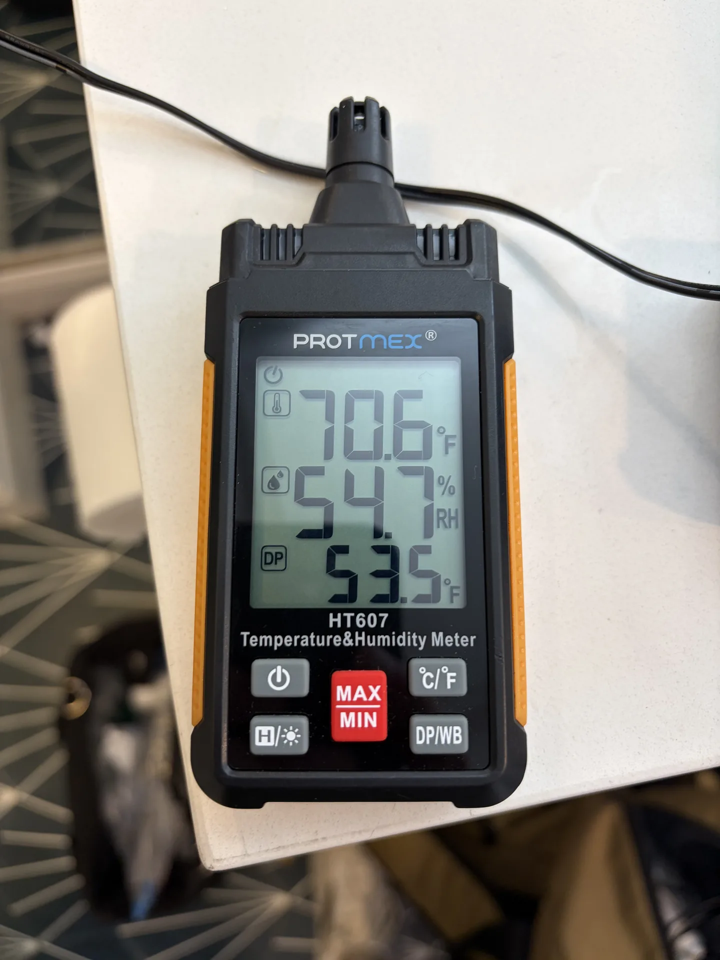 Top-floor bathroom hygrometer displaying 70.6 degrees Fahrenheit, 54.7 percent relative humidity and a 53.5 degree Fahrenheit dew point